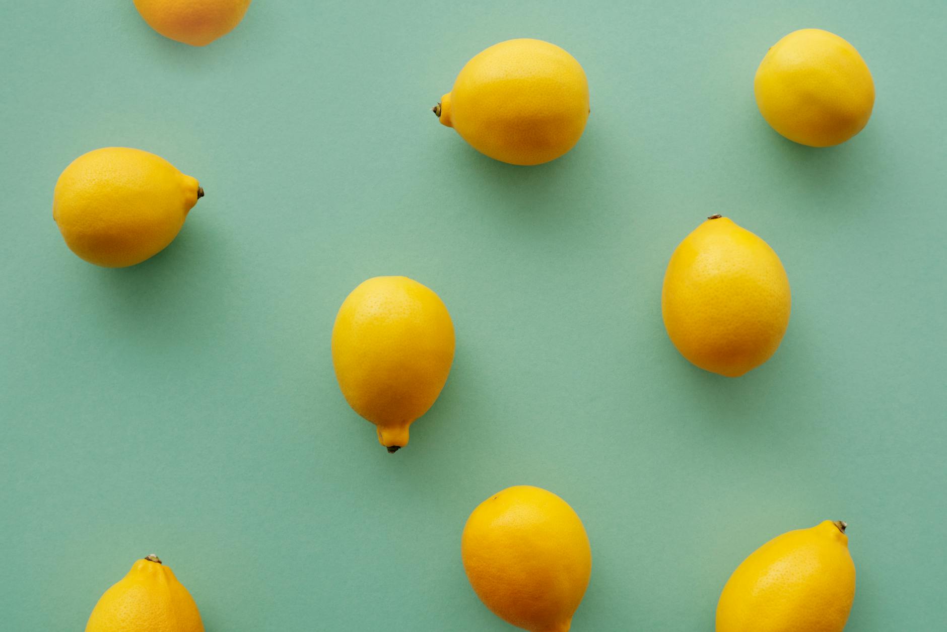 Bright yellow lemons on a pastel green background symbolizing the fresh, intentional approach to pleasure choices
