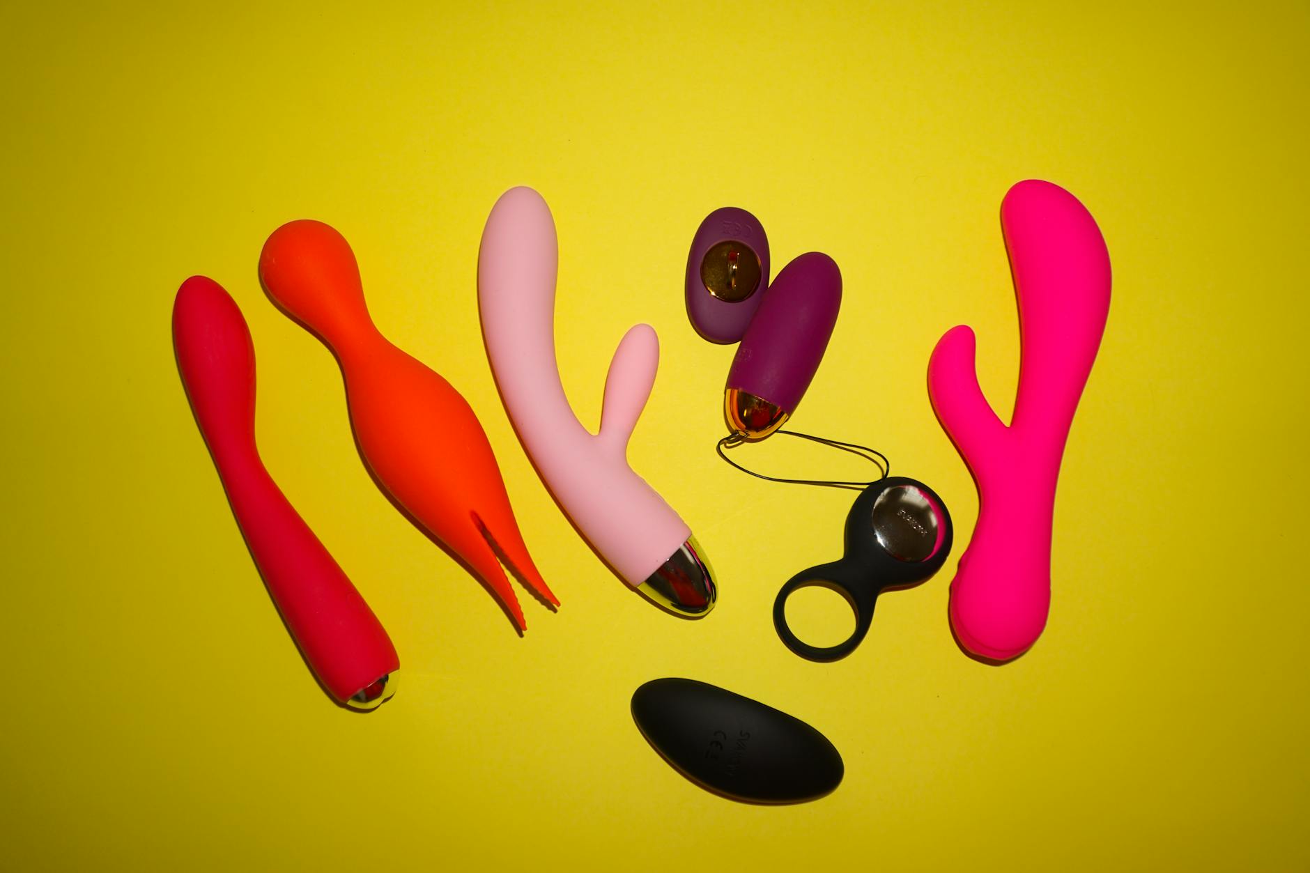Hands holding a sleek blue vibrator against a purple background, symbolizing self-initiated pleasure