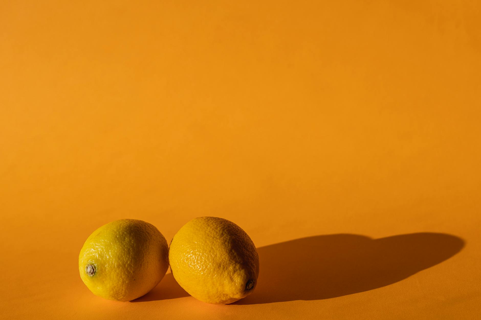 Yellow silicone vibrator with peeled bananas on bright yellow background